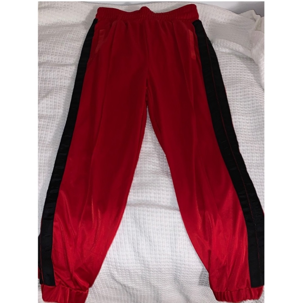 Red joggers, black stripe down the side
